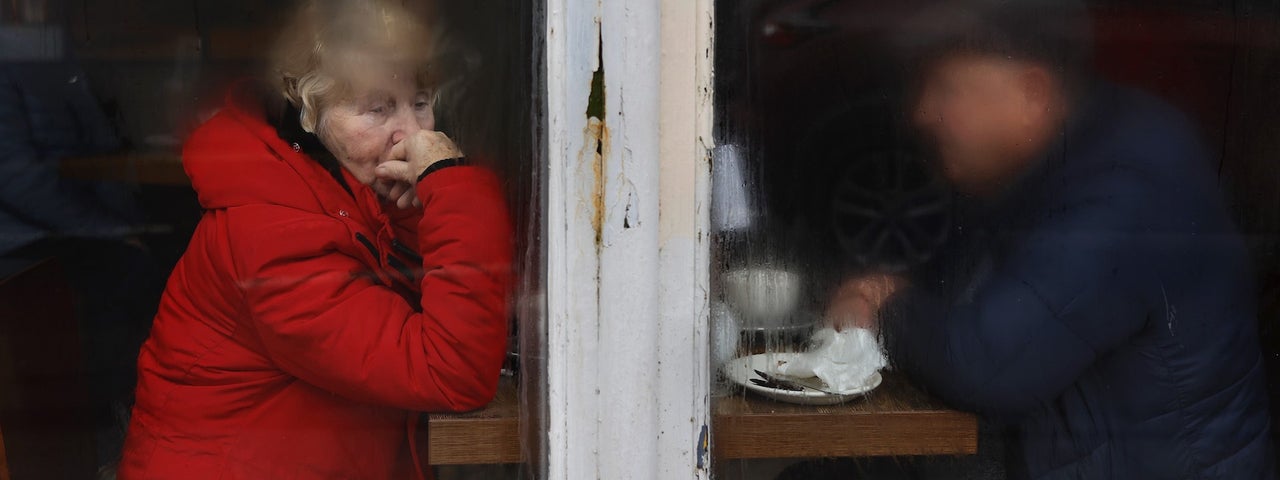 Elderly couple sitting on other side of window, half fogged, drizzly morning, man obscured by condensation and woman stares out of frame to the bottom right. Copyright David Stephenson.