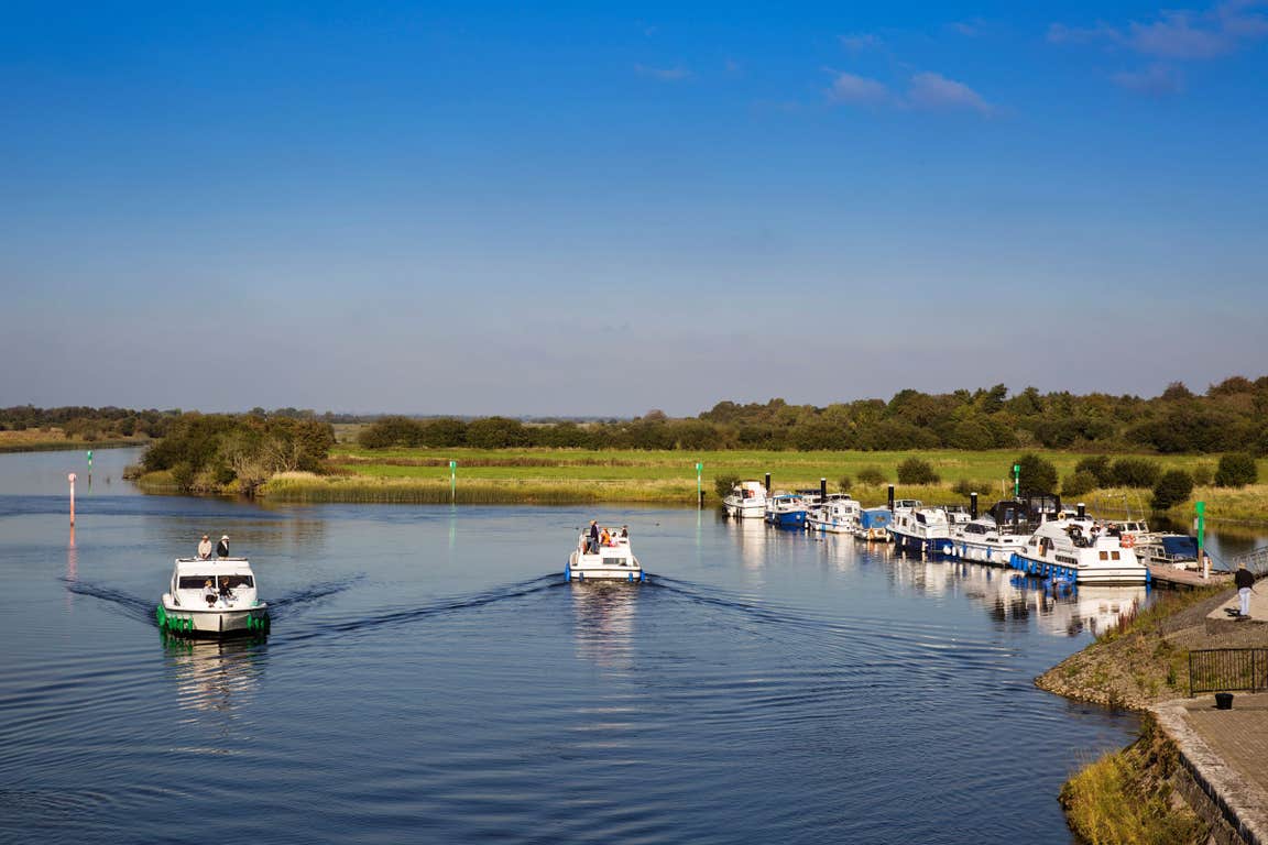 Boats cruising along the still waters of the River Shannon