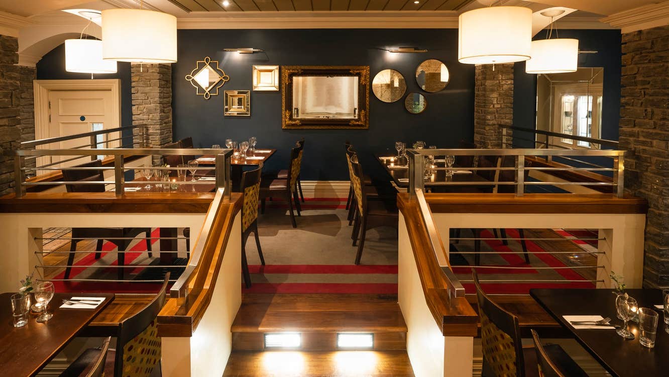 Restaurant interior with steps leading to an upper level of seating