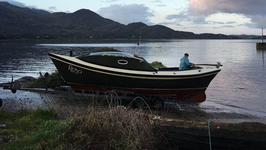 A boat moored beside the sea with its skipper