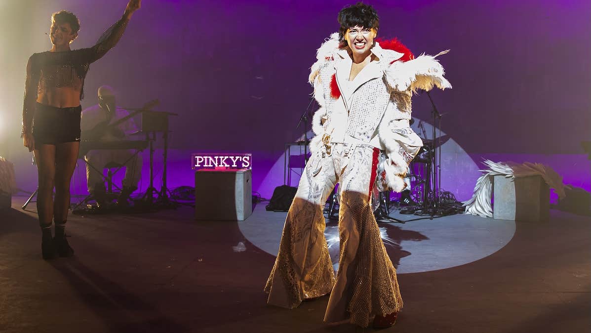 0800 Cupid _ Emer Dineen _ Thisispopbaby - a person performing on a stage in a fancy, white Elvis costume