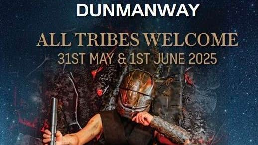 A person with face covered by dark metal mask is seated on rough, rocky throne holding light sabre.