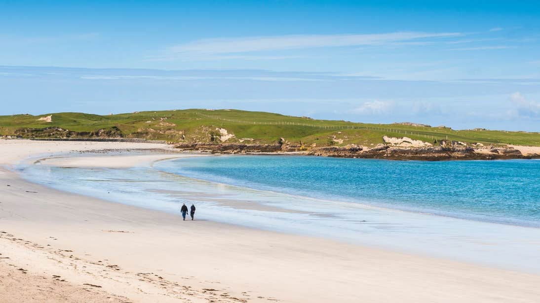 Two people walking on Dog's Bay Beach, Co Galway