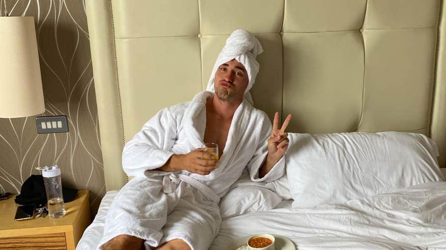 Greg O'Shea relaxing on a bed in a hotel in Sligo