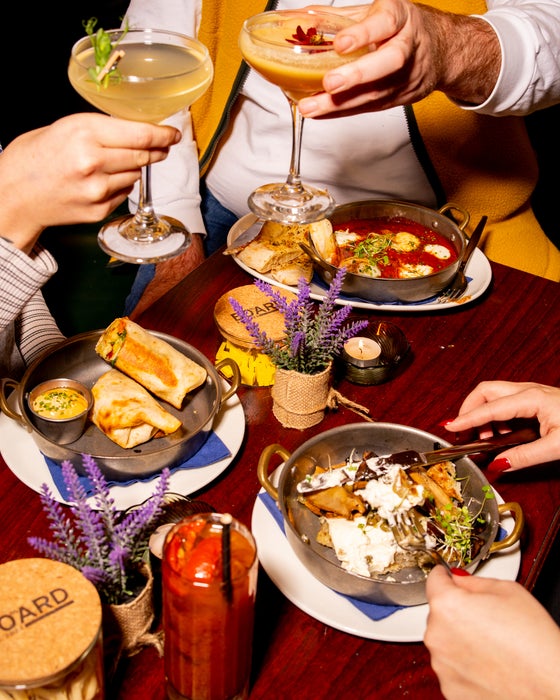 A table of mocktails and dinner dishes at Board.