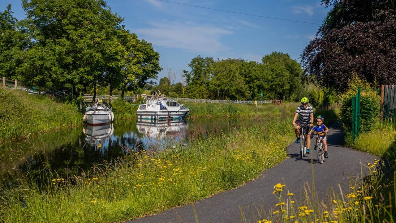 Two cyclists on a river path