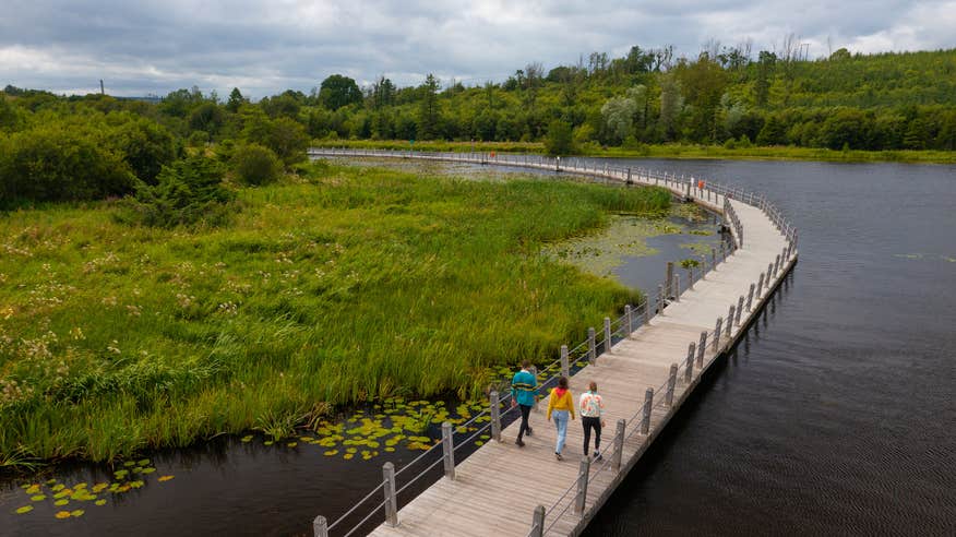 People walking on the Acres Lake Floating Boardwalk in Drumshanbo, Co Leitrim