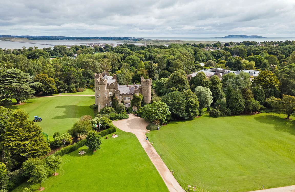 Malahide Castle and Gardens aerial view of the castle with Malahide Estuary in the distance