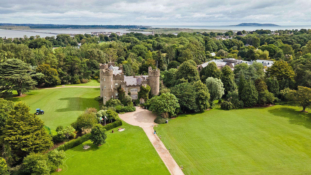 Malahide Castle and Gardens aerial view of the castle with Malahide Estuary in the distance