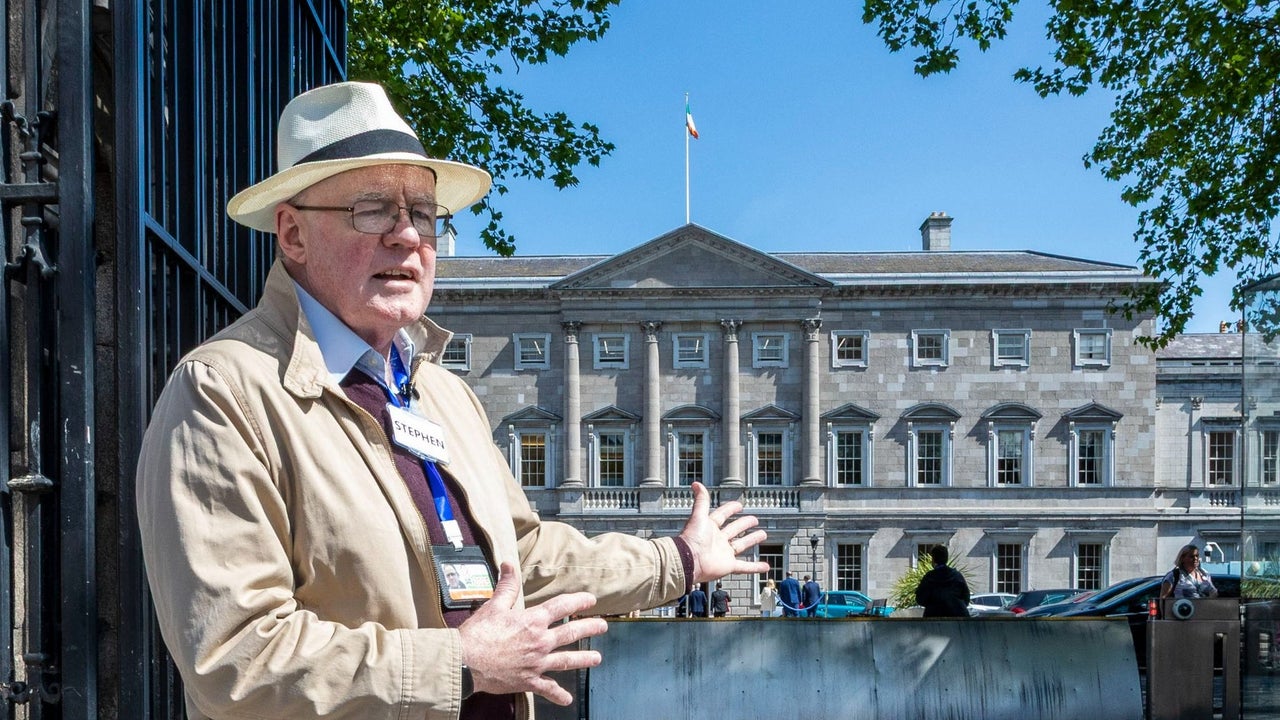 A man giving a tour in front of Leinster House