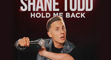 Shane Todd - Hold Me Back, a man with questioning expression is holding up a mic horizontally in front of him.