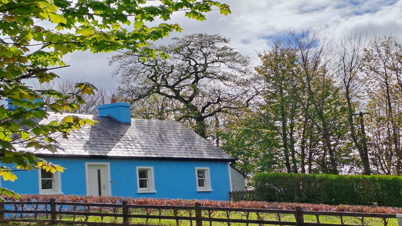 Front view of blue house and gardens