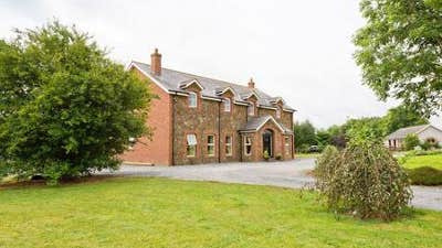 Side view of house with green garden