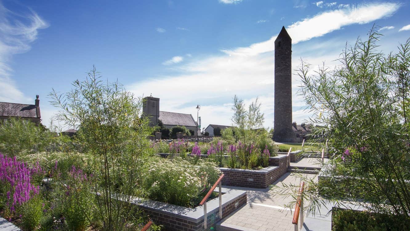 Round tower surrounded by steps flowers and greenery