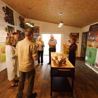 A group of people indoors at a bee and honey demonstration
