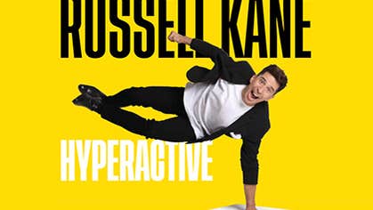 A man is horizontal balancing on his left hand on a white box with shouting expression on face, against bright yellow background with black or white text.