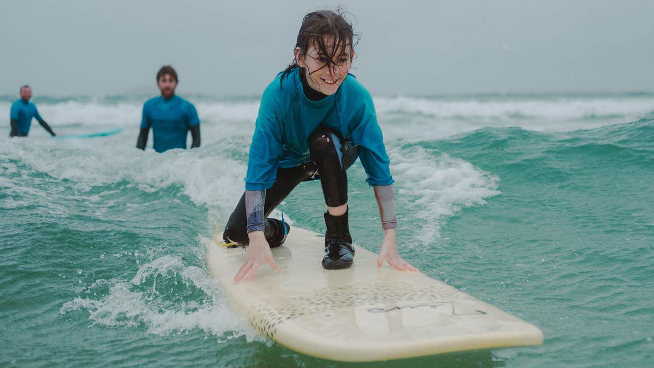 Child learning to surf in County Mayo.