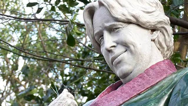 Head and shoulders of a painted stone statue of a man