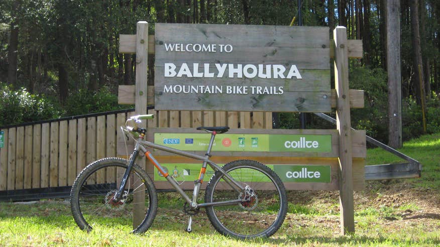 A grey hardtail bike resting against a sign in Ballyhoura, Limerick