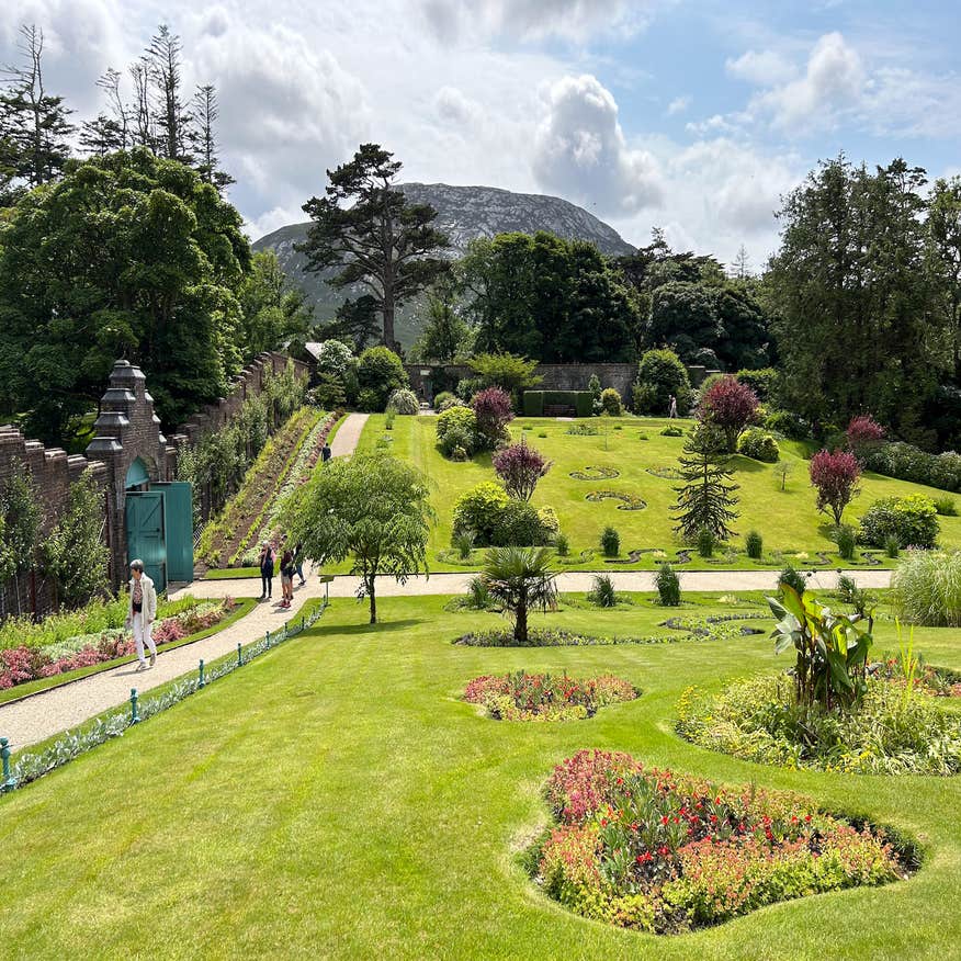 People walking in the Walled Gardens at Kylemore Abbey in County Galway.