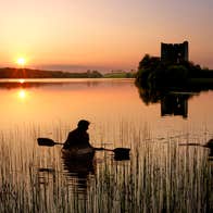 People kayaking in Lough Oughter, Co Cavan at sunset