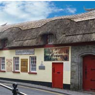 The exterior of the Cashel Folk Village with its thatched roof