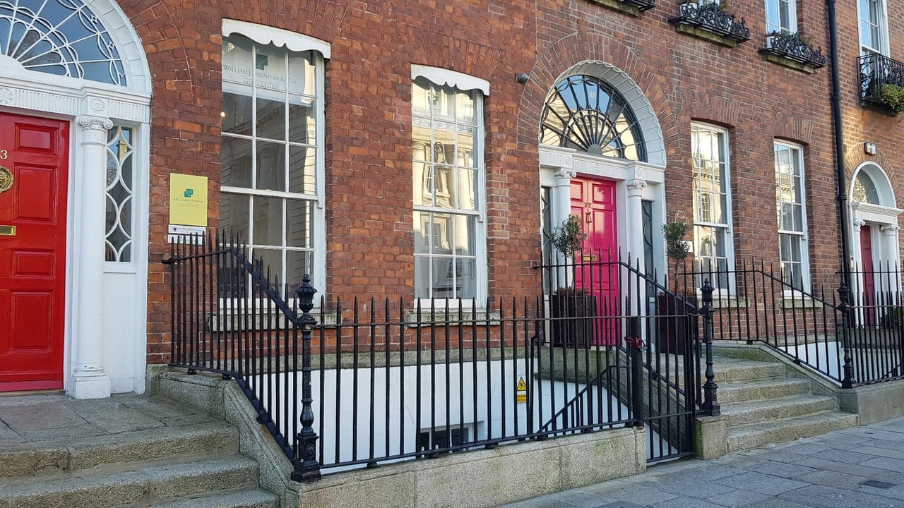Red brick Georgian terrace in Dublin city with red doors