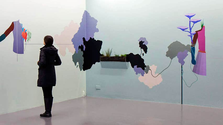 A person admiring some wall art in the gallery