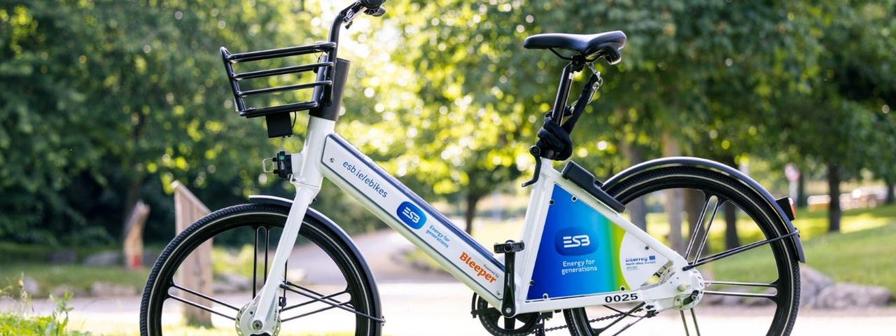 A lone electric bike posed in an upright position in a park