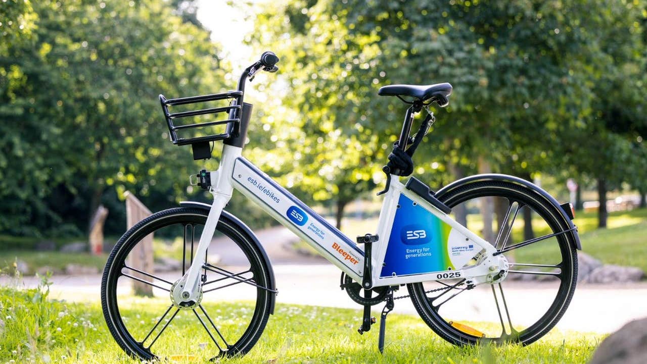 A lone electric bike posed in an upright position in a park