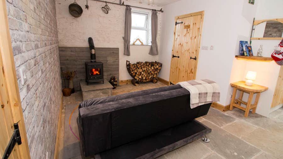 Sitting room with a couch and stove