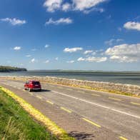 A car driving the Shannon Estuary Way in County Limerick