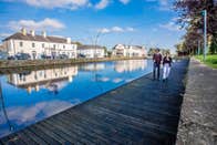 A couple walk the boardwalk along by the Royal Canal in Maynooth