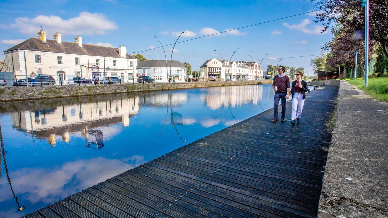 A couple walk the boardwalk along by the Royal Canal in Maynooth