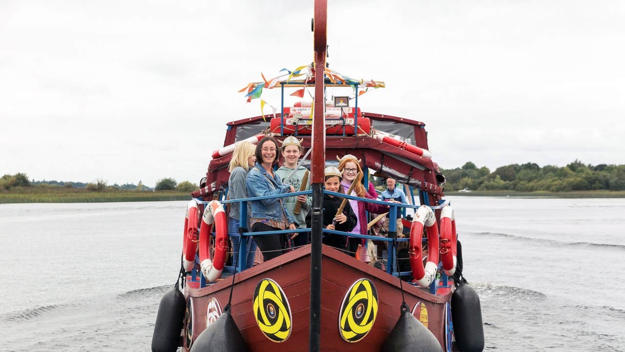 People enjoying a Viking Tours sailing to Clonmacnoise on a Viking heritage boat