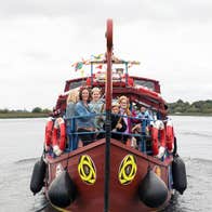People enjoying a Viking Tours sailing to Clonmacnoise on a Viking heritage boat