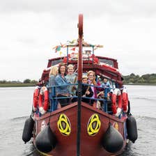 People enjoying a Viking Tours sailing to Clonmacnoise on a Viking heritage boat