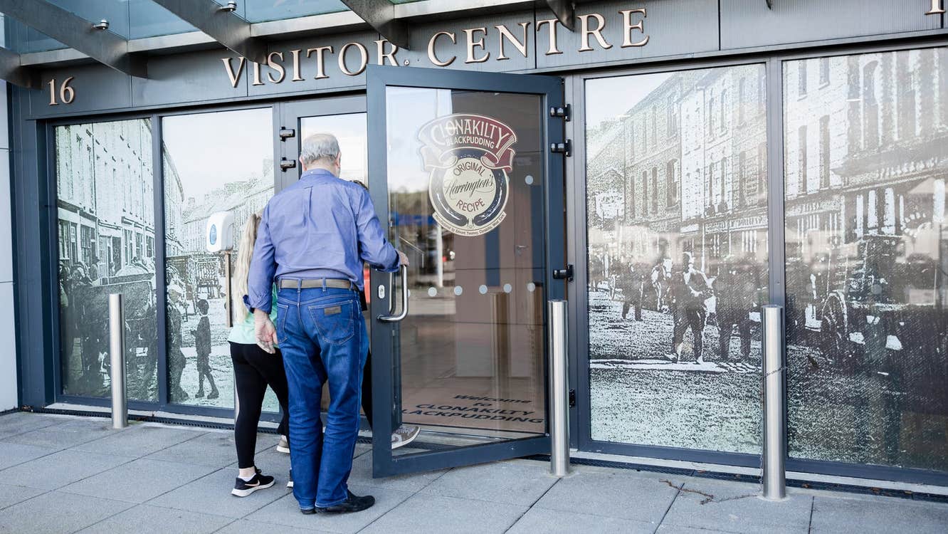 Two people opening the door to the Clonakilty Blackpudding Visitor Centre