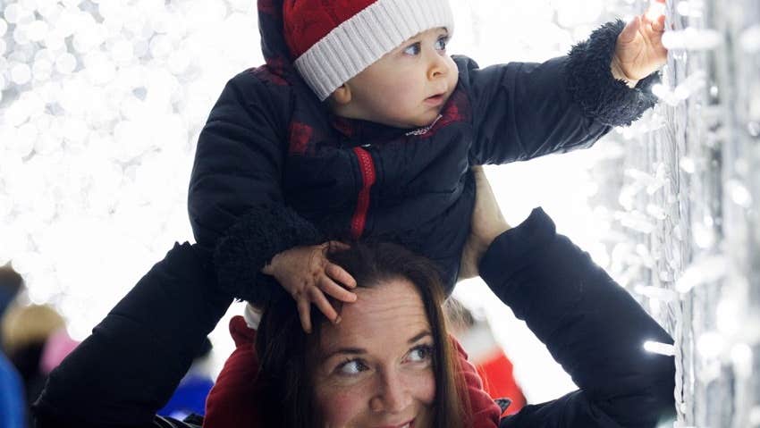 Wonderlights at Malahide Castle - a baby on the shoulders of an adult looking with wonder a white lights