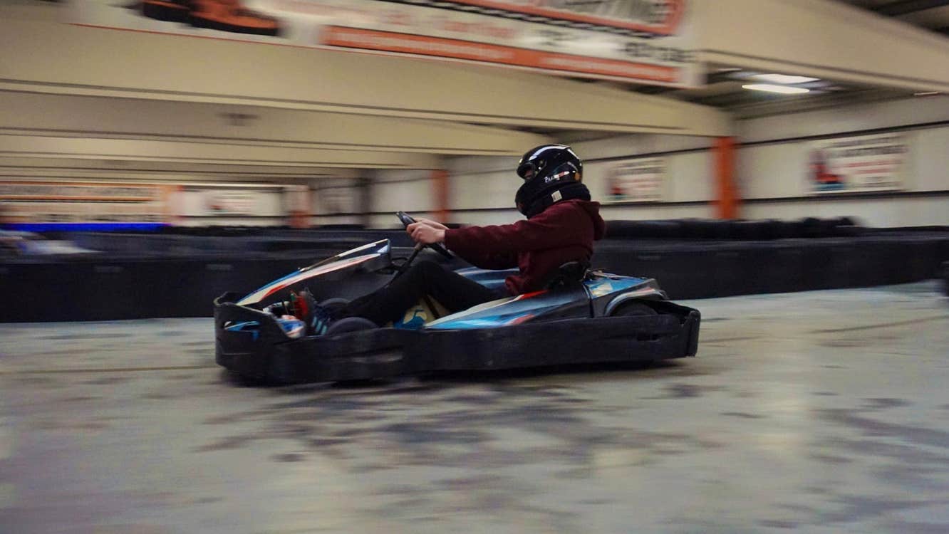Image of a person driving a kart on an indoor track