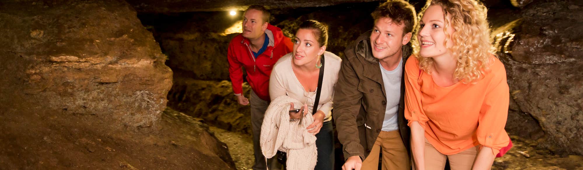 Four people exploring the Mitchelstown Caves in County Cork