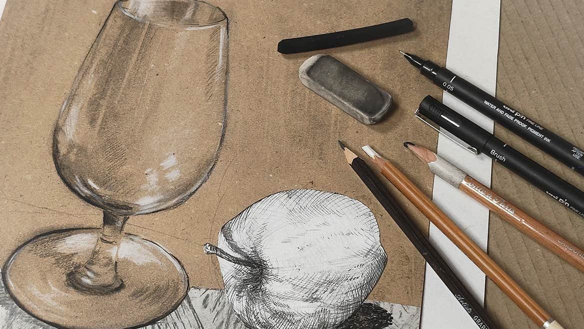 A sketch of a glass and an apple with pencils laid on it.