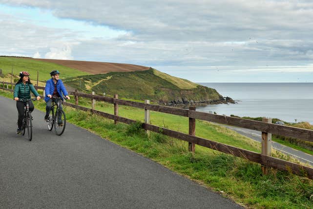 Couple cycling through Dungarvan, County Waterford