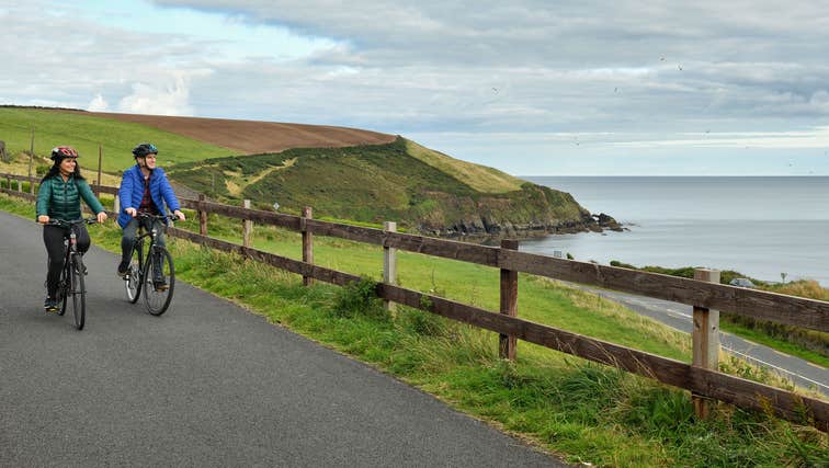 Couple cycling through Dungarvan, County Waterford