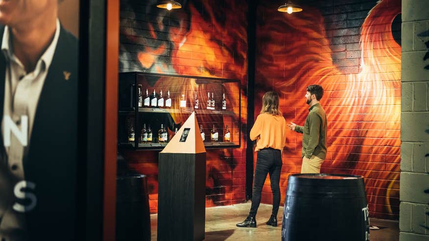 A couple looking at a display inside the Teeling Whiskey distillery.