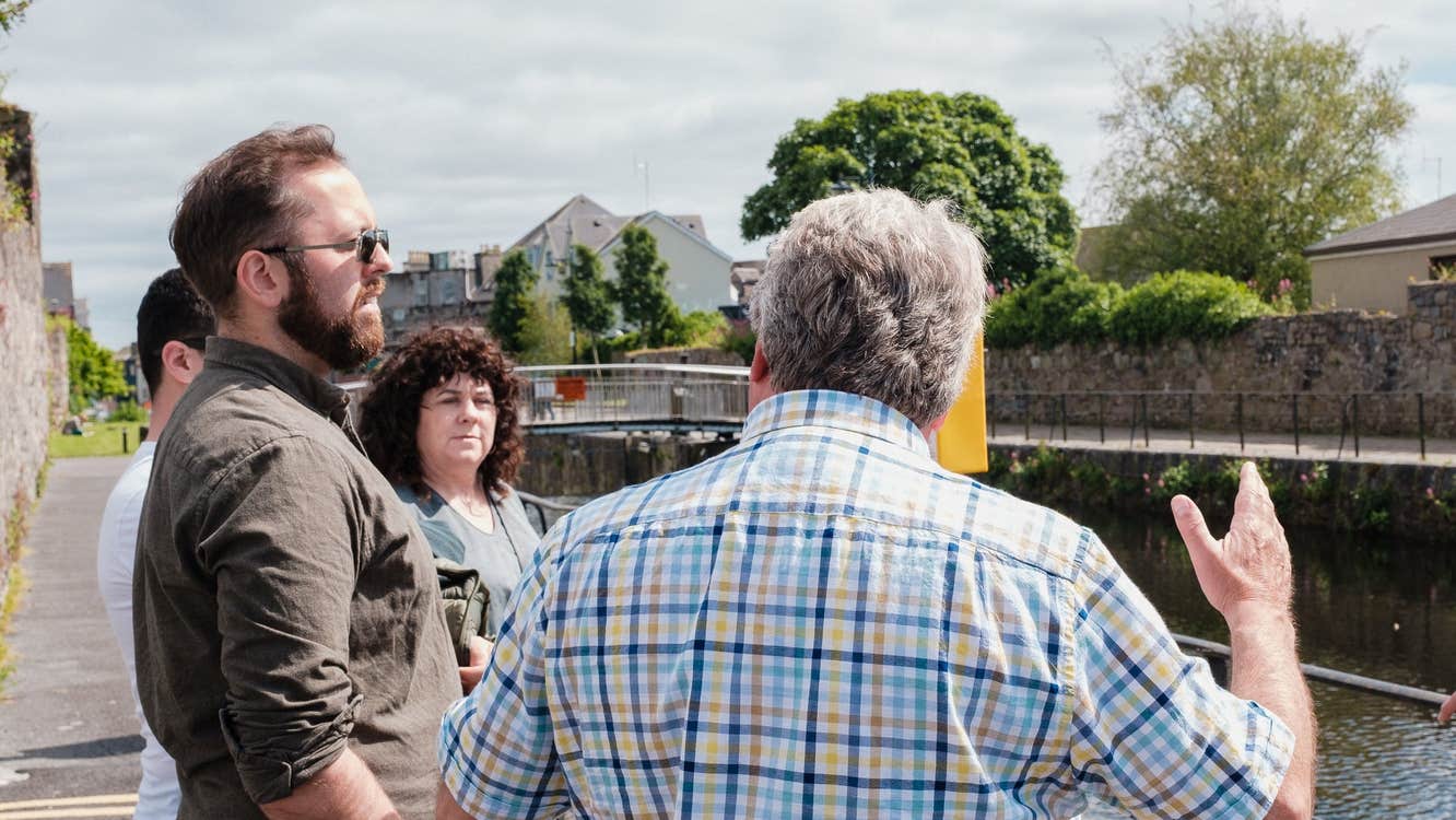 Walking Tours of Galway's Westend guide talking to his group along Eglinton Canal