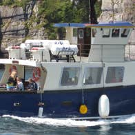 A boat at sea with passengers onboard