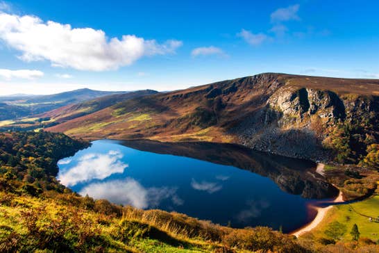 A sunny day with some clouds reflected on Lough Tay, Wicklow Mountains National Park