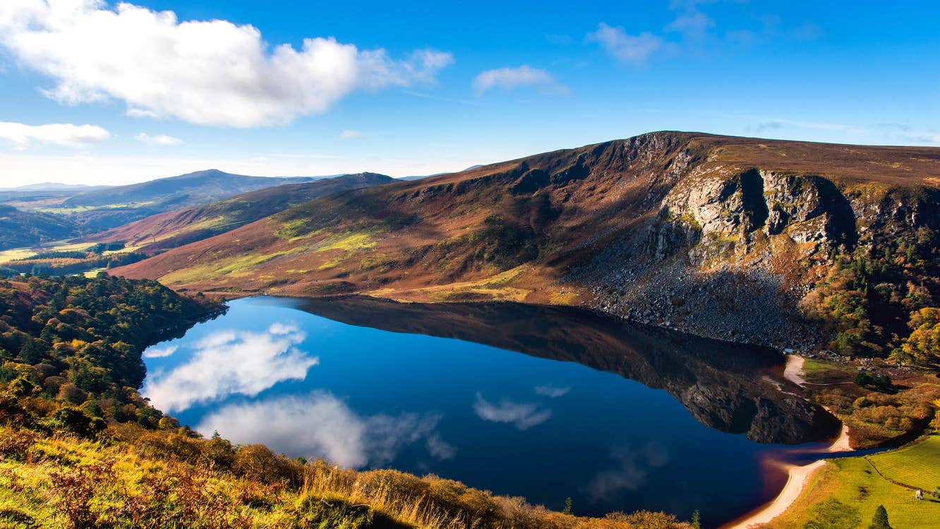 A sunny day with some clouds reflected on Lough Tay, Wicklow Mountains National Park