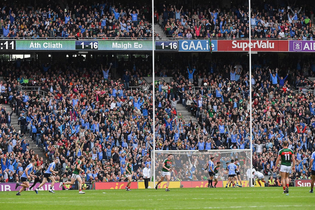 A GAA match with thousands of fans in the stands cheering on their favourite teams.